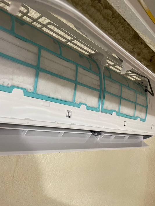 Photo of a frozen MRCOOL ductless mini split line set and air handler, used to illustrate freezing issues caused by airflow or refrigerant problems.