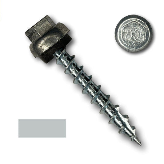 A #12 x 1.5" ZXL Dome Cap Metal Roofing Screw (Metal-to-Wood) from Perma Cover with a hexagonal head and a washer attached lies diagonally on a white background. Next to it is a separate round metallic washer with a decorative design. A gray rectangular shape is also visible on the left side of the image, showcasing #12 x 1.5" ZXL Dome Cap Metal Roofing Screws (Metal-to-Wood) - 250 Pack from Perma Cover.