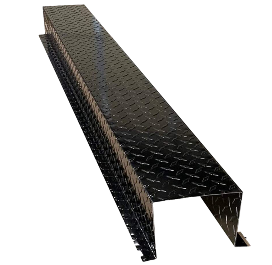 A long, black, metal diamond plate ramp with a rectangular shape and slightly elevated sides, equipped with Perma Cover Residential Series - Aluminum Diamond Plate HVAC Line Set Cover Extensions - Additional 5 Foot Extension Section to provide a gradual incline for heavy equipment or vehicles.