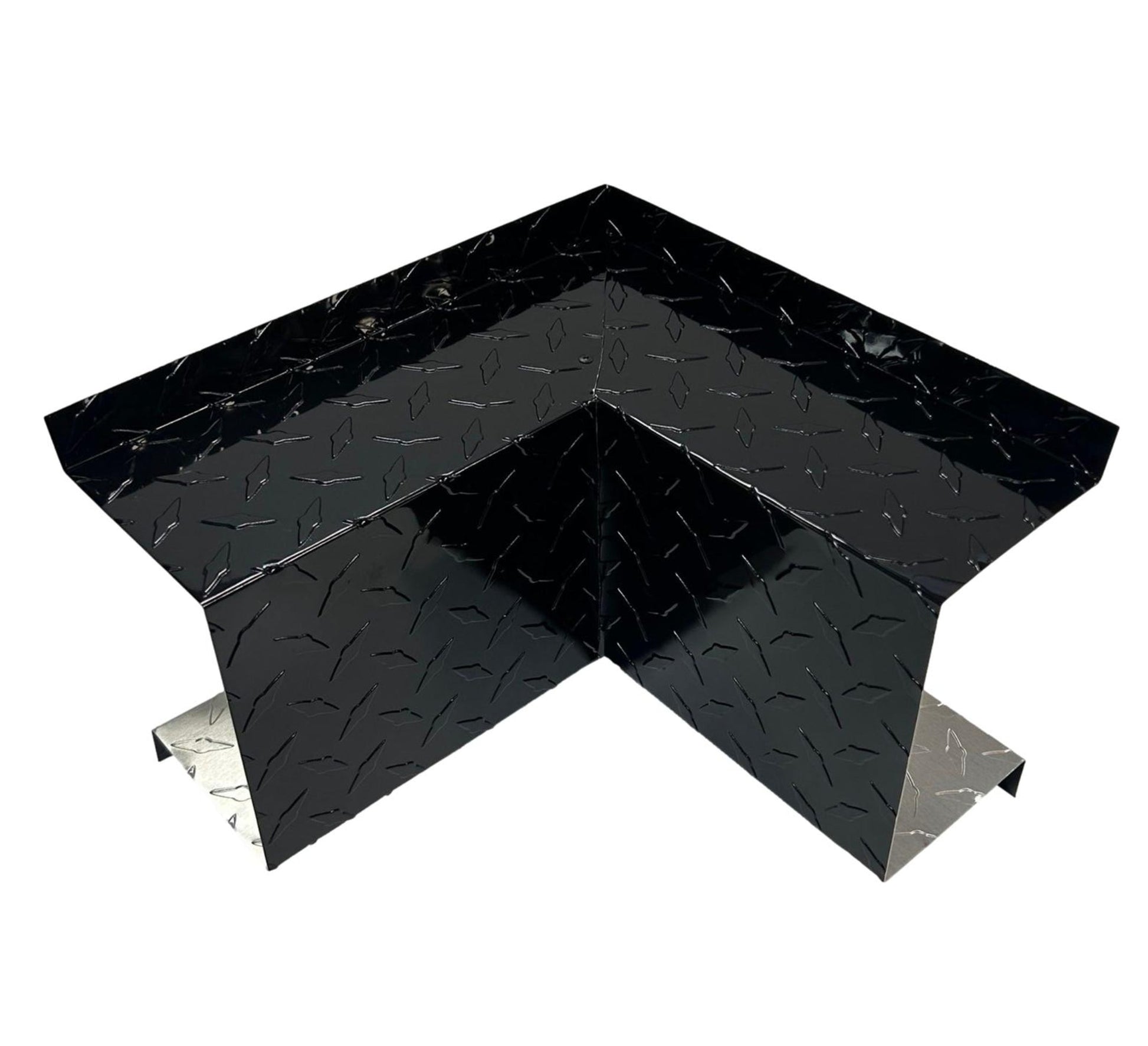 A black, metal Residential Series - Line Set Cover Inside Corner Elbows - Premium Quality with a textured, diamond plate surface pattern, designed for use in construction or structural support applications. The Perma Cover product has a right-angle shape and reflective silver edges, making it ideal for HVAC installations and other structural tasks.