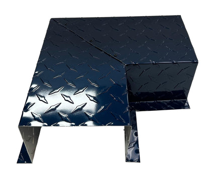 A black, L-shaped metal cover with a diamond plate pattern, designed for industrial purposes, provides protection or housing for equipment or machinery. The shiny surface reflects light, highlighting the raised diamond shapes. Its design ensures easy installation and fits seamlessly with Perma Cover Residential Series - Line Set Cover Side Turning Elbows - Premium Quality in HVAC line sets.