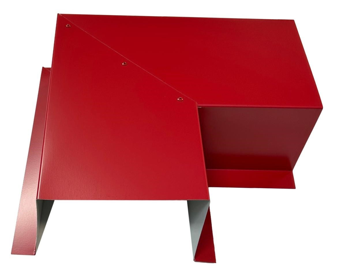 A red, modern, geometric metal sculpture with angular planes and sharp edges. The structure consists of interconnected panels forming abstract triangular and rectangular shapes, giving it a dynamic and contemporary appearance. Featuring Perma Cover Residential Series - Line Set Cover Side Turning Elbows - Premium Quality, it ensures easy installation against the plain white background.