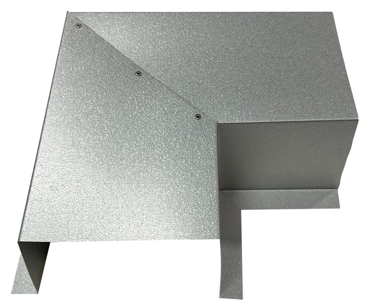 A metallic, angular object featuring several flat, intersecting planes and reflective surfaces. The design includes bolts and right-angled folds, giving it a modern, geometric appearance. Crafted from Perma Cover Residential Series - Line Set Cover Side Turning Elbows - Premium Quality for HVAC line sets, it promises durability and easy installation in industrial settings.