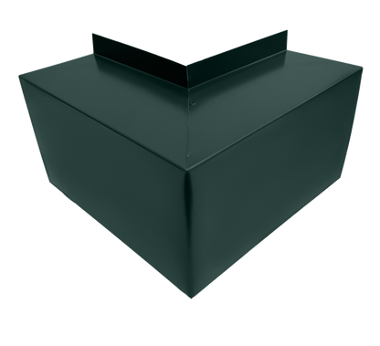 A close-up view of a dark green, angular metal structure with sharp edges and a v-shaped top. The object appears to be a decorative or functional element, possibly the Perma Cover Commercial Series - 24 Gauge Line Set Cover Outside Corner Elbows - Premium Quality, crafted from 24 gauge steel elbows for easy installation in architectural or construction settings.