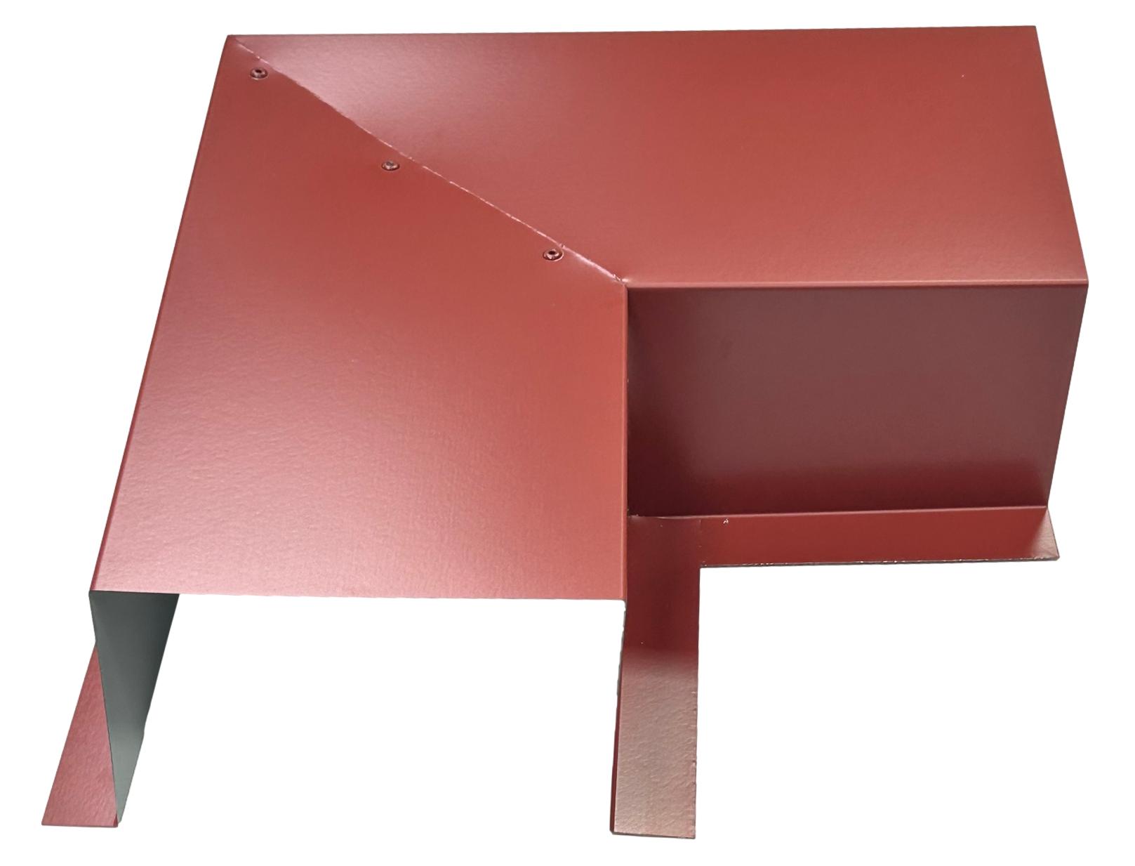 A red, angular metal object with sharp edges and a geometric design, featuring a flat section and raised portion. There are visible screws on the top surface. The step-like structure and overhanging part suggest integration with HVAC line sets, ensuring easy installation. This object is the Residential Series - Line Set Cover Side Turning Elbows - Premium Quality by Perma Cover.