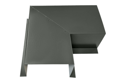 A gray, angular metal object made from premium quality 24 gauge steel features overlapping rectangular and triangular sections, forming a geometric, abstract 3D shape. The surface appears smooth and matte. The Perma Cover Commercial Series - 24 Gauge Line Set Cover Side Turning Elbows - Premium Quality has sharp, clean edges and seems to be industrially designed for easy installation.