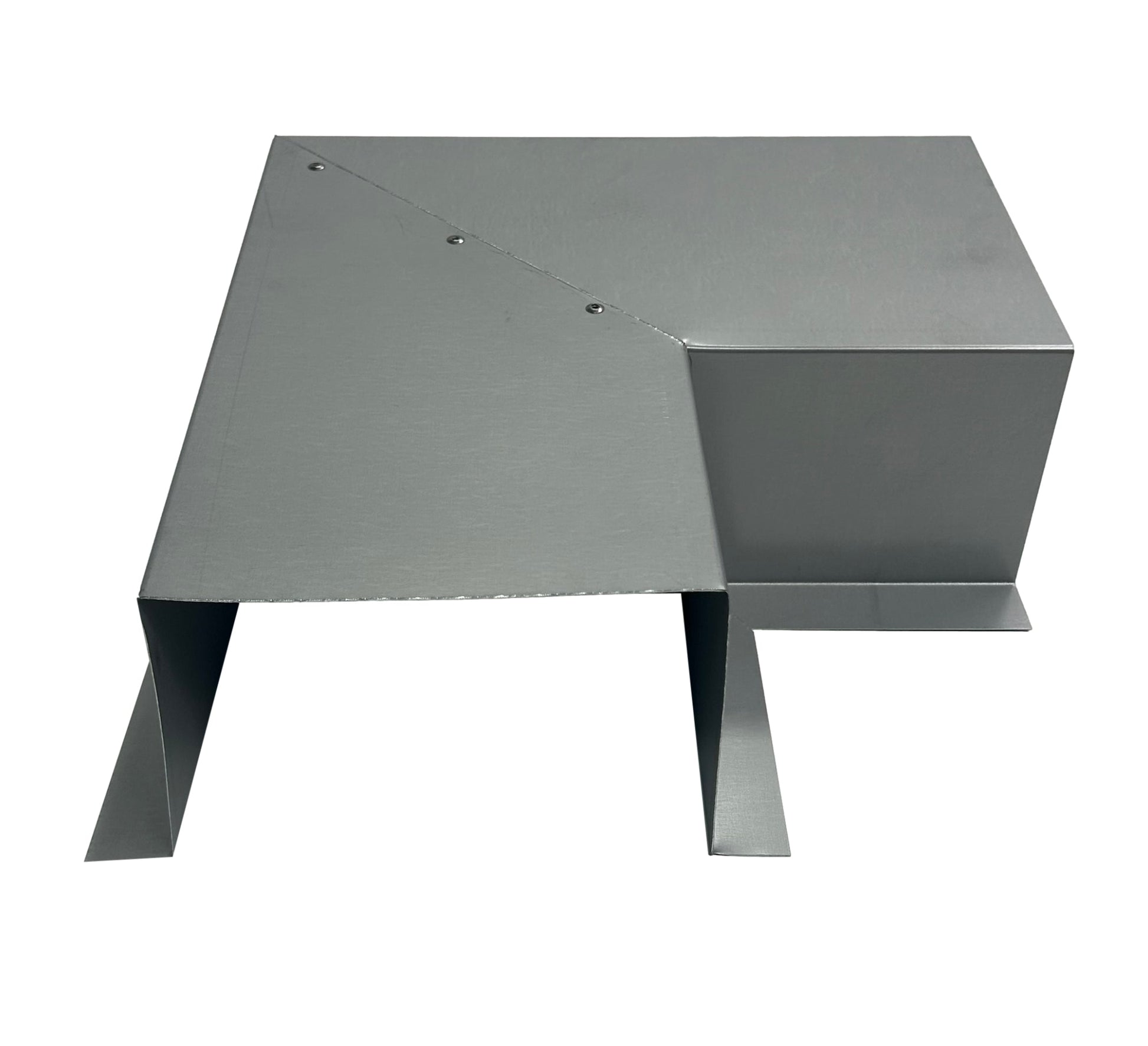 A gray, metallic vent cover with a rectangular box shape on one side and an angled, triangular flap extending downward. Featuring rivets along the edge of the angled part, this Perma Cover Residential Series - Line Set Cover Side Turning Elbows - Premium Quality sits on a flat surface, possibly for use in HVAC systems or ductwork for easy installation.