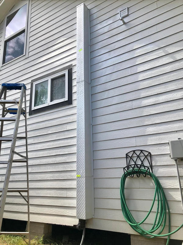 Vertical HVAC line set covers protecting refrigerant lines and wiring outdoors