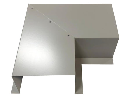 A light gray, angular metal object with three visible screws on the top surface. The object has multiple intersecting planes and sharp edges, reminiscent of Perma Cover's Residential Series - Line Set Cover Side Turning Elbows - Premium Quality used in HVAC line sets. It appears to be a piece of industrial or architectural metalwork designed for easy installation.
