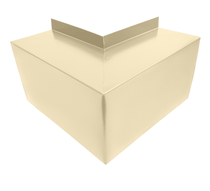 A beige, three-dimensional box with a triangular prism shape on top, creating an angular, modern appearance. Made of smooth, reflective material for a sleek look and easy installation. The background is a light beige color, complementing the Perma Cover Commercial Series - 24 Gauge Line Set Cover Outside Corner Elbows - Premium Quality seamlessly.