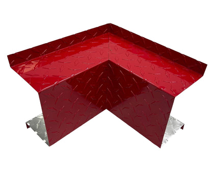A red and silver Perma Cover Residential Series - Line Set Cover Inside Corner Elbows - Premium Quality with a textured, diamond plate surface. Designed to fit over an external corner, it provides protection and reinforcement. Perfect for HVAC installations, the red coating covers two sides while the silver metal is visible underneath.