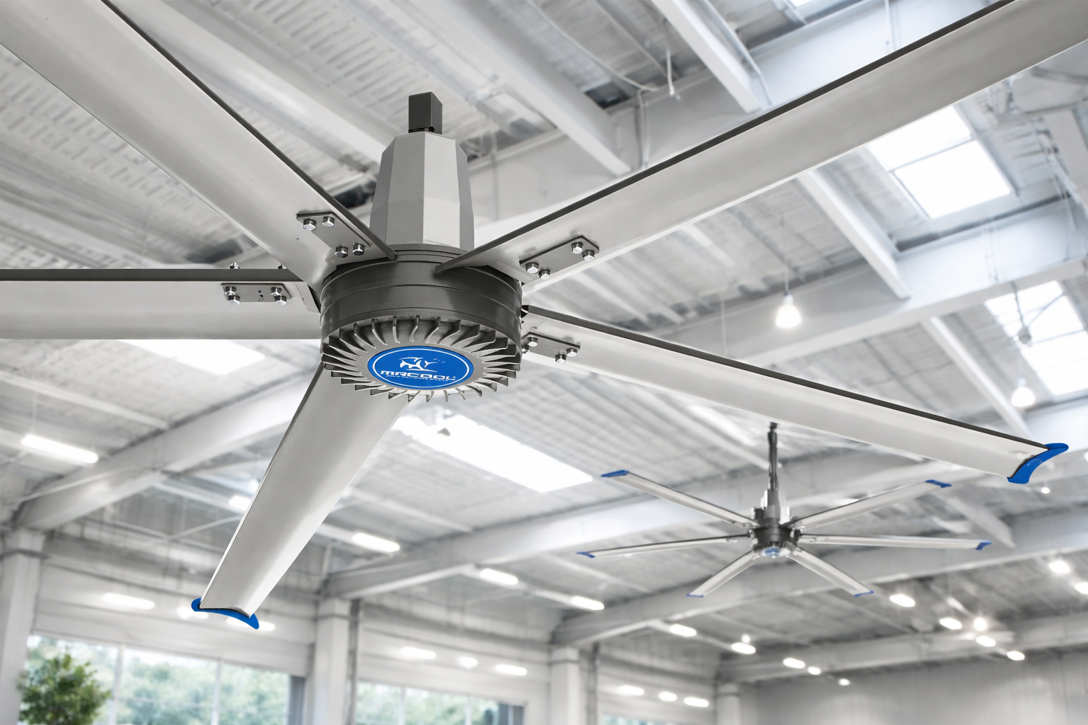 MRCOOL HVLS ceiling fan installed in large warehouse with high ceilings and multiple industrial fans for air circulation