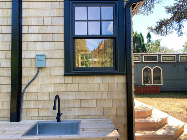 PermaCover metal HVAC line set covers installed on exterior wall for a mini split system
